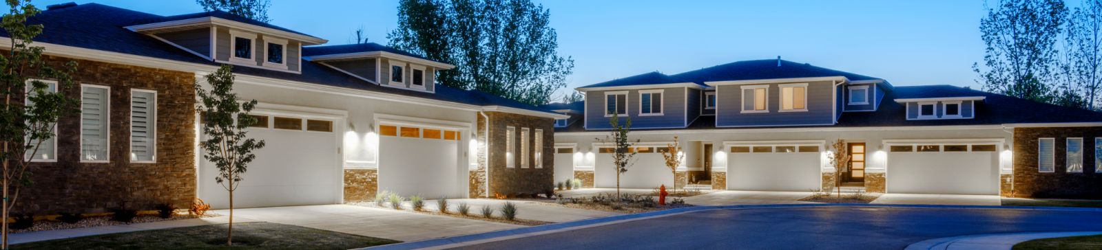 A view on suburban houses with big garages at dusk